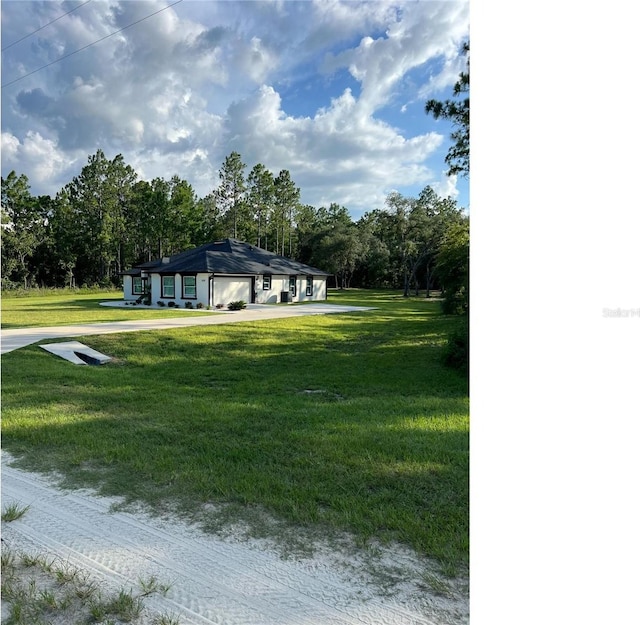 view of front of property with a front yard, a carport, and driveway