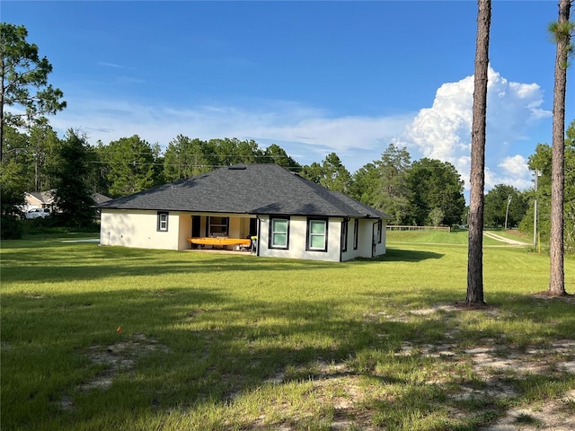 rear view of property featuring a yard