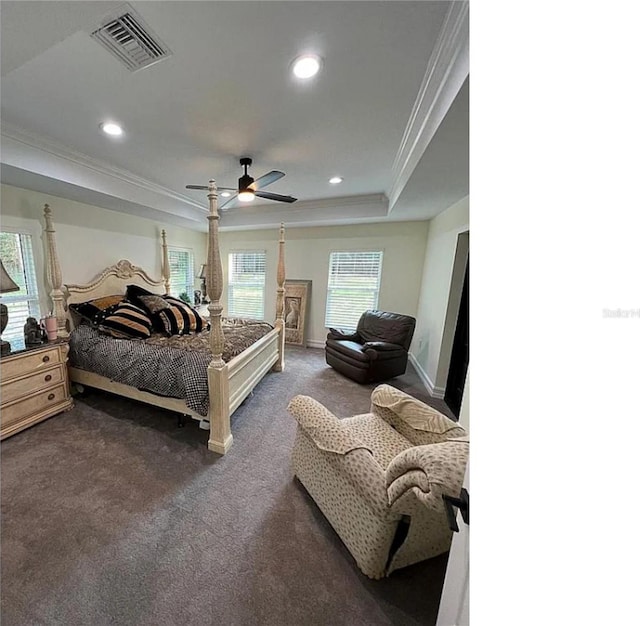 bedroom with visible vents, recessed lighting, ornamental molding, a raised ceiling, and dark colored carpet