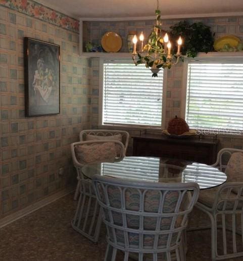 dining area with a wealth of natural light and an inviting chandelier