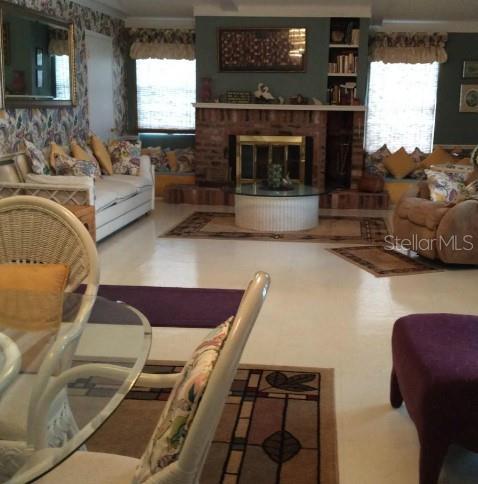 living room featuring a brick fireplace