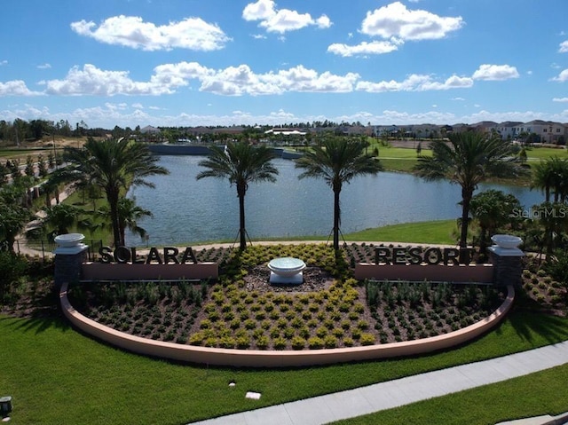 view of home's community with a yard and a water view