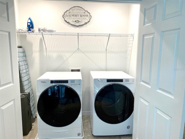 laundry area featuring light tile patterned flooring and washer and dryer