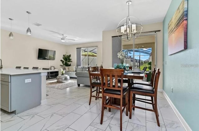 dining area with ceiling fan with notable chandelier