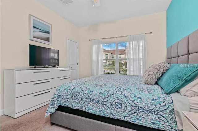 bedroom with ceiling fan and light carpet