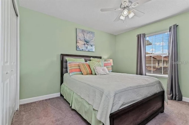 bedroom featuring light carpet, a closet, and ceiling fan