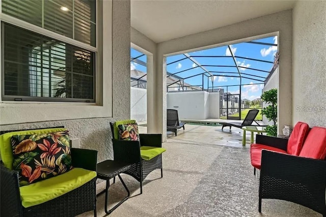 view of patio featuring an outdoor living space and glass enclosure