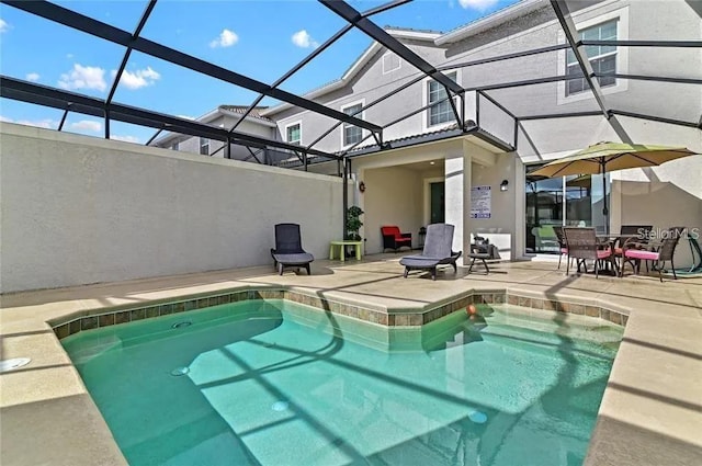 view of swimming pool with a lanai and a patio