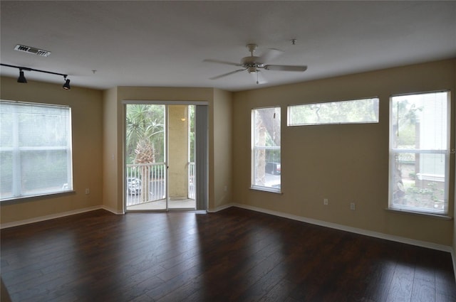 unfurnished room featuring baseboards, visible vents, ceiling fan, and dark wood-style flooring