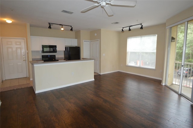 kitchen with black appliances, dark wood finished floors, visible vents, and white cabinetry