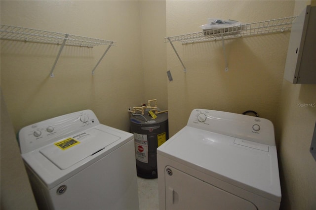 laundry room featuring water heater, laundry area, electric panel, and independent washer and dryer