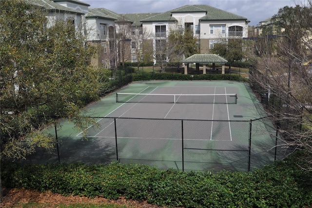 view of tennis court featuring fence