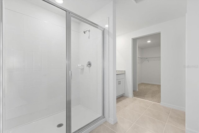 bathroom featuring vanity, tile patterned flooring, and an enclosed shower