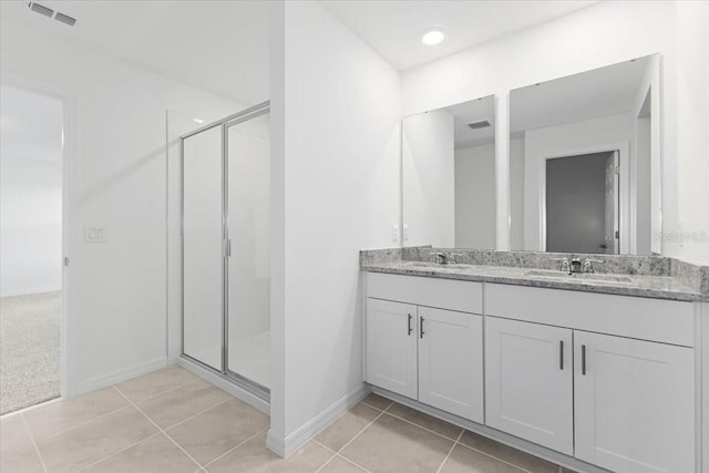 bathroom with vanity, tile patterned flooring, and an enclosed shower