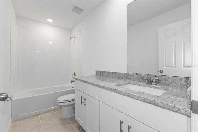 full bathroom with vanity, tiled shower / bath combo, toilet, and tile patterned floors