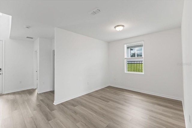 spare room with light hardwood / wood-style flooring