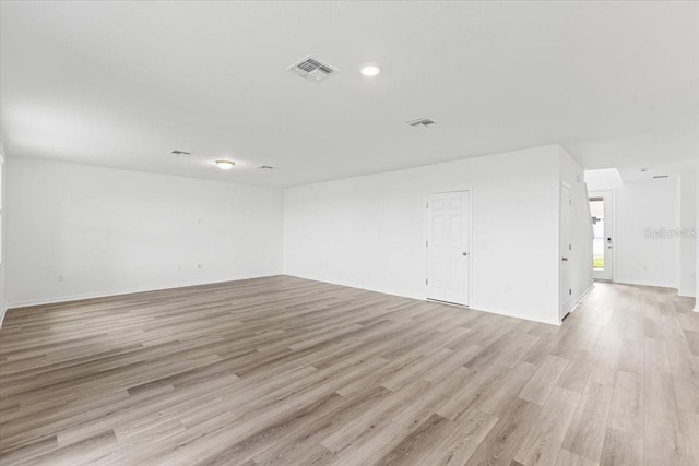 unfurnished room with light wood-type flooring