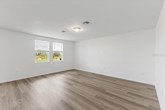 unfurnished room with light hardwood / wood-style flooring