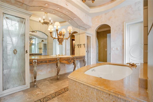 bathroom with vanity, crown molding, and a tub to relax in