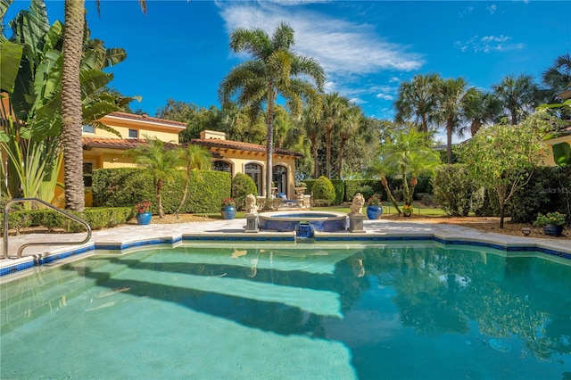 view of swimming pool with an in ground hot tub