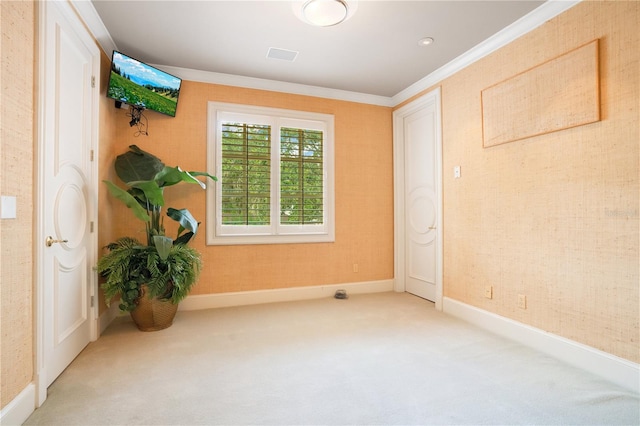 unfurnished room featuring ornamental molding and carpet flooring