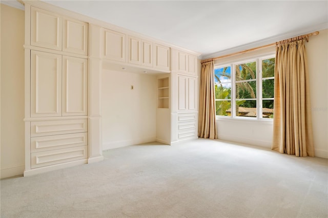 unfurnished bedroom with light carpet and a closet