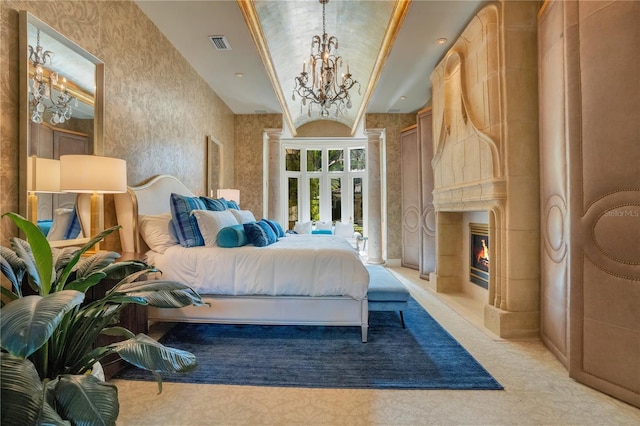 carpeted bedroom featuring ornamental molding, a chandelier, and a fireplace