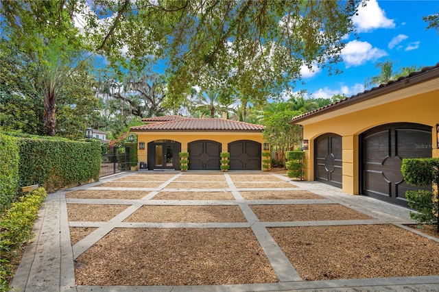 mediterranean / spanish house with a garage