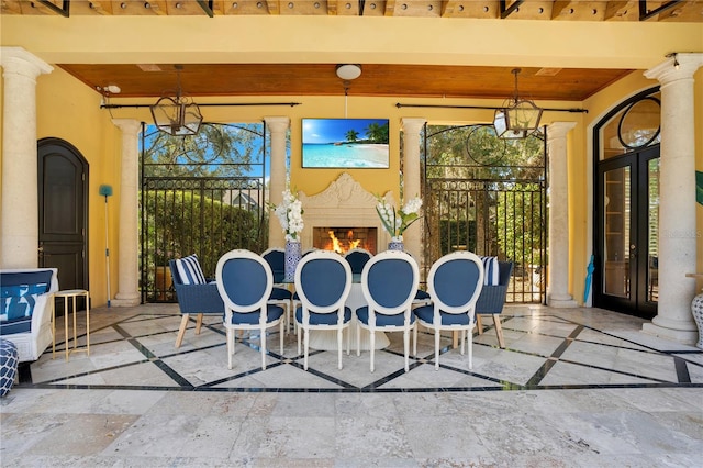 exterior space with an outdoor fireplace, beam ceiling, wooden ceiling, and plenty of natural light