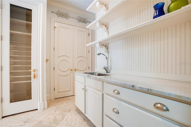 interior space with ornamental molding and sink