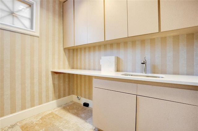 washroom with sink and cabinets