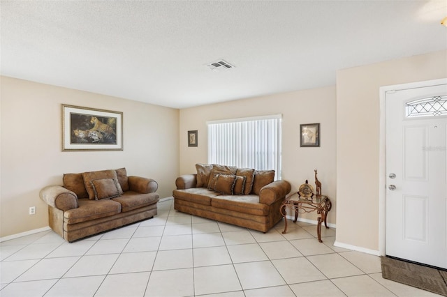 living room featuring light tile patterned floors and a textured ceiling