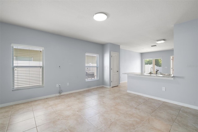 tiled empty room featuring sink