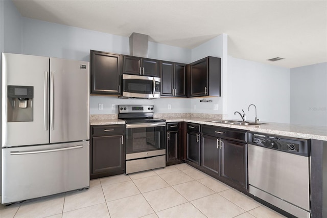 kitchen featuring light stone counters, sink, light tile patterned floors, and stainless steel appliances