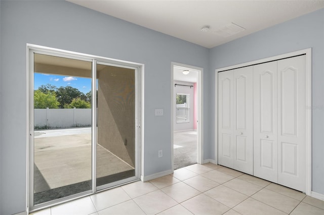 unfurnished bedroom with light tile patterned floors and a closet