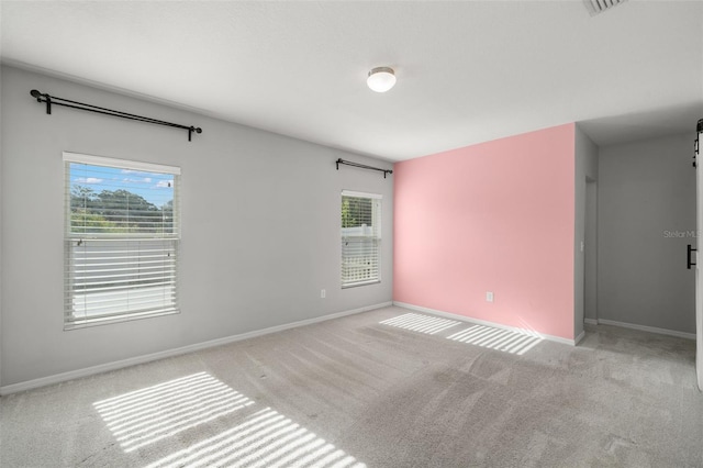 carpeted empty room with plenty of natural light