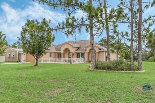 ranch-style home featuring a front yard