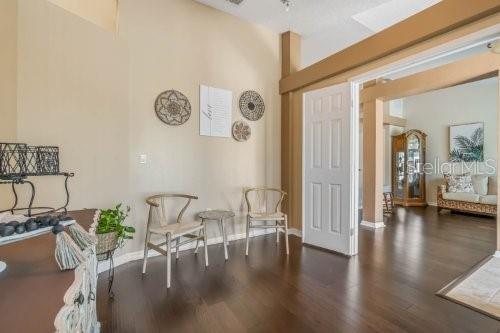 sitting room with dark wood-type flooring