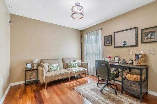 office space with baseboards and wood finished floors