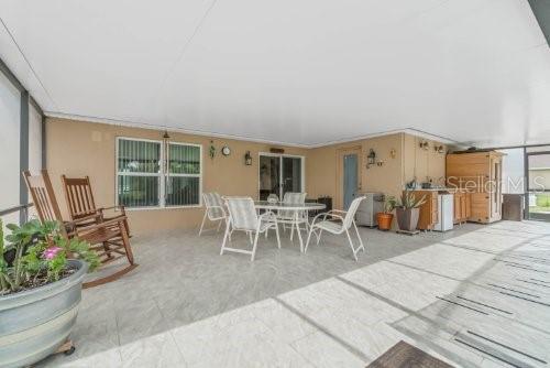 rear view of property with a patio area, stucco siding, and outdoor dining space