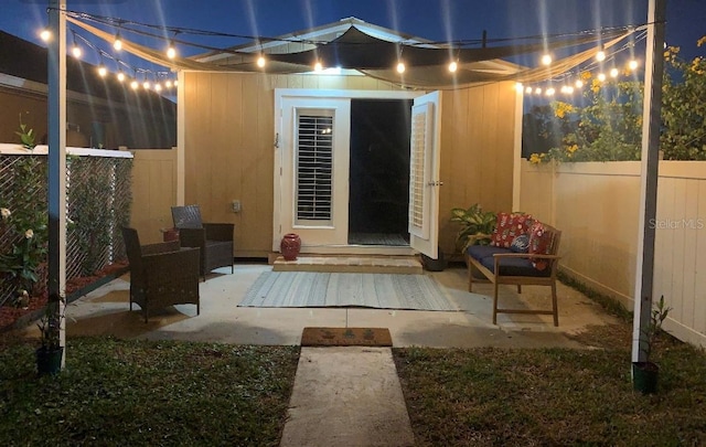 doorway to property featuring a patio area and fence