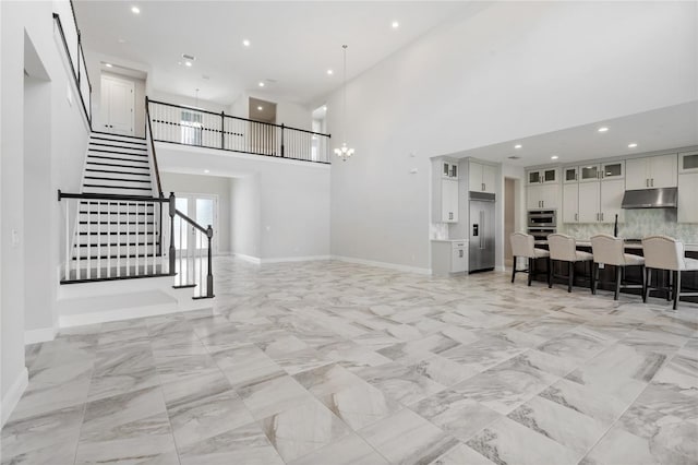 living room featuring a towering ceiling