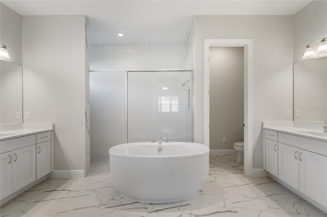 full bathroom featuring toilet, vanity, and separate shower and tub