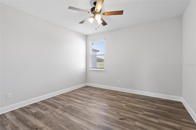 unfurnished room with a textured ceiling, dark hardwood / wood-style floors, and ceiling fan