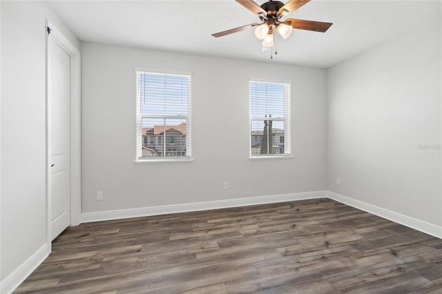 unfurnished room featuring dark hardwood / wood-style floors and ceiling fan