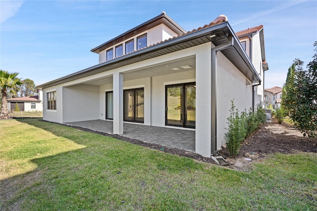 rear view of property with a yard