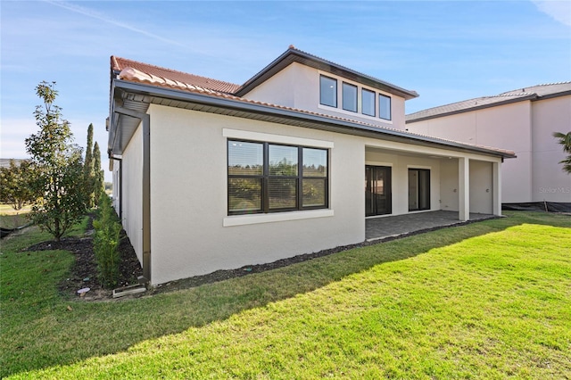 rear view of house featuring a yard