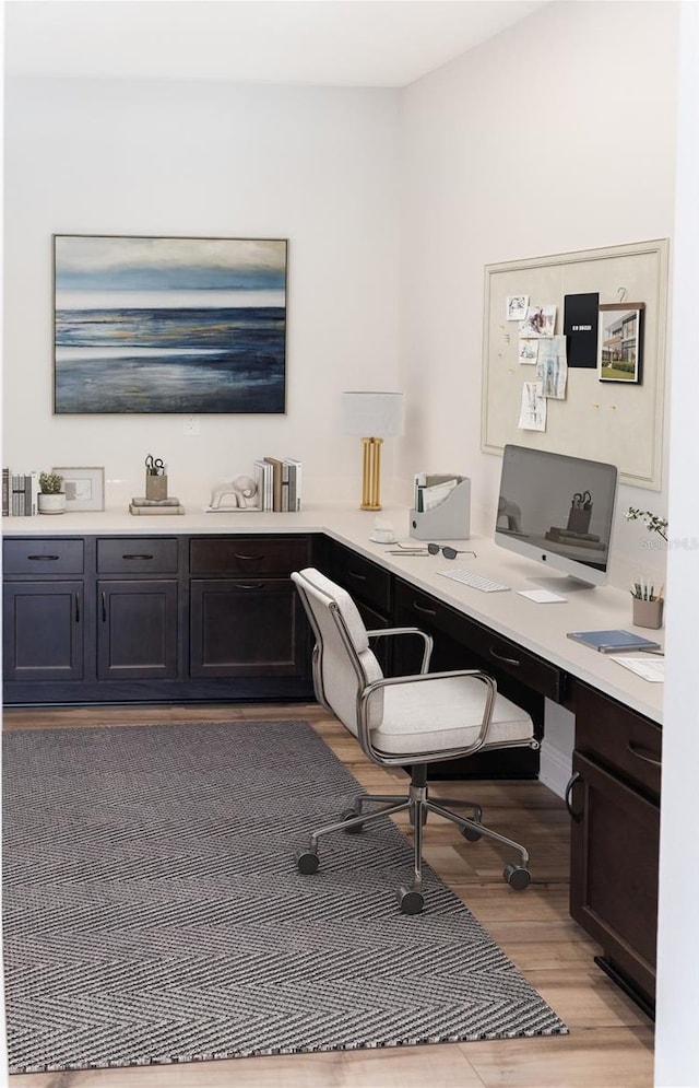 office area featuring built in desk and light hardwood / wood-style flooring