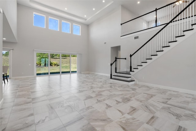 unfurnished living room featuring a high ceiling