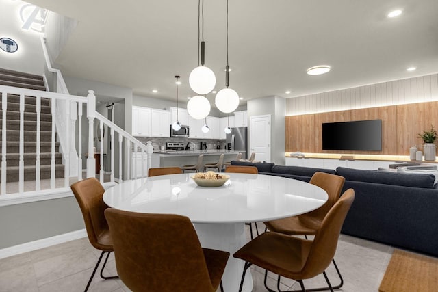 tiled dining room featuring wooden walls